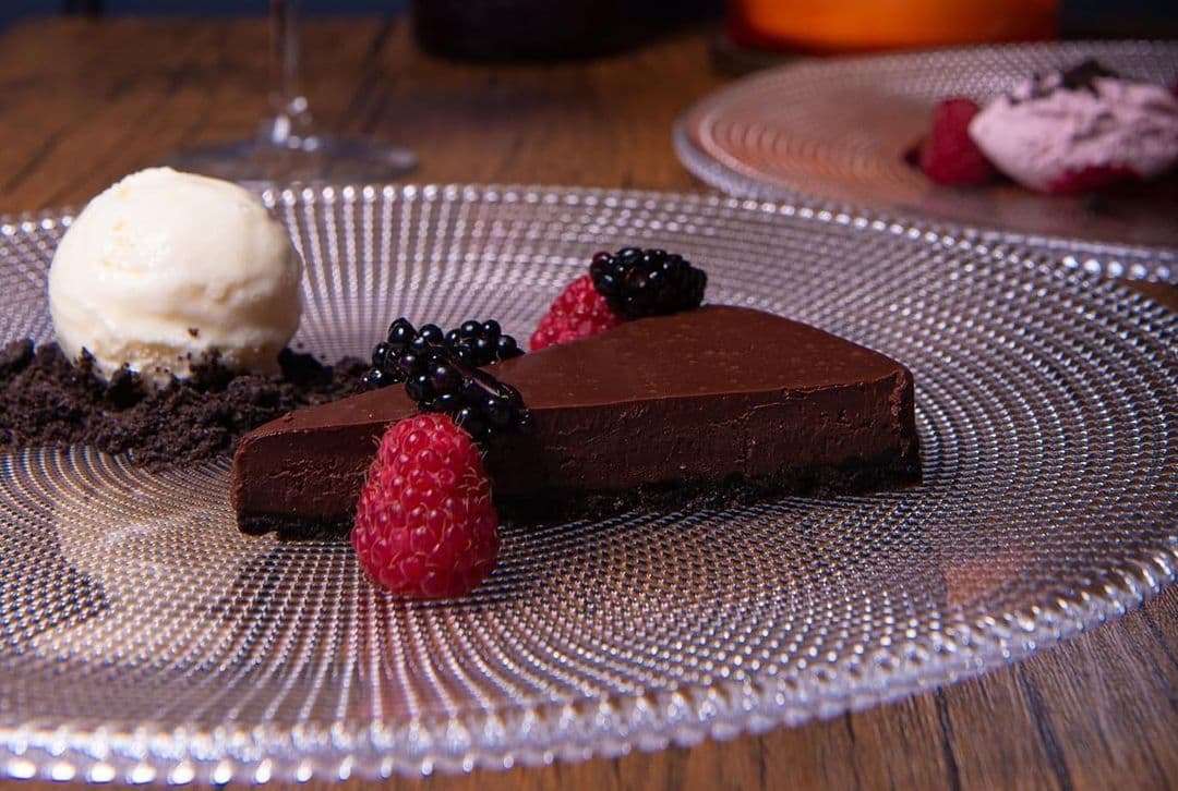 Chocolate tart with berries and vanilla ice cream