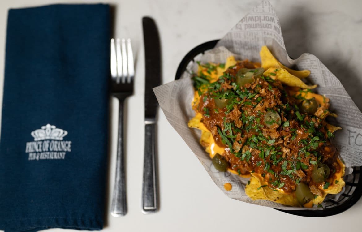 Loaded nachos with chilli, cheese sauce and jalapeños