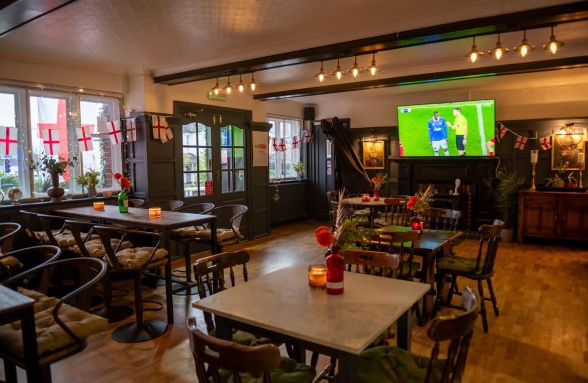 Dining room with football on the big screen